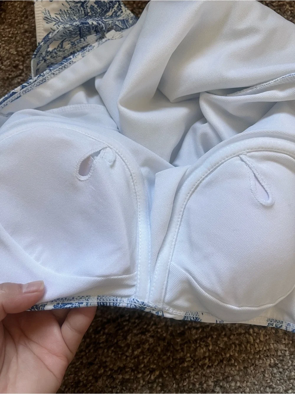 White and navy onepiece swimsuits with matching coverup.